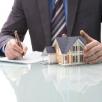 Man signs purchase agreement for a  house
